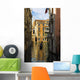 Italy, Venice, Rowing gondola through canal Wall Mural