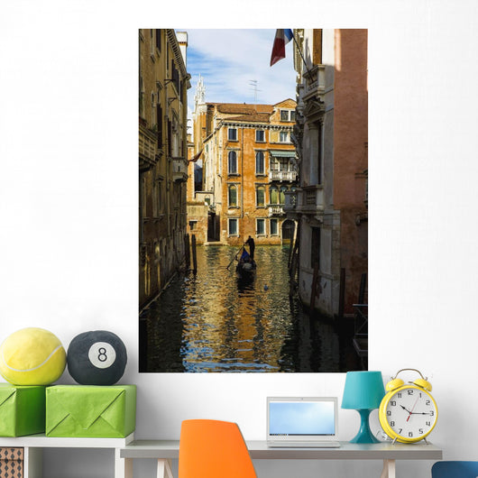 Italy, Venice, Rowing gondola through canal Wall Mural