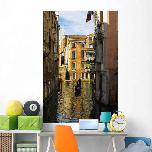 Italy, Venice, Rowing gondola through canal Wall Mural