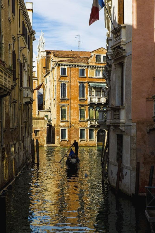 Italy, Venice, Rowing gondola through canal Wall Mural