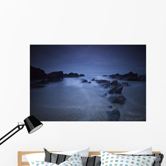 Long exposure of rocks on the beach at night;Newquay cornwall england Wall Mural