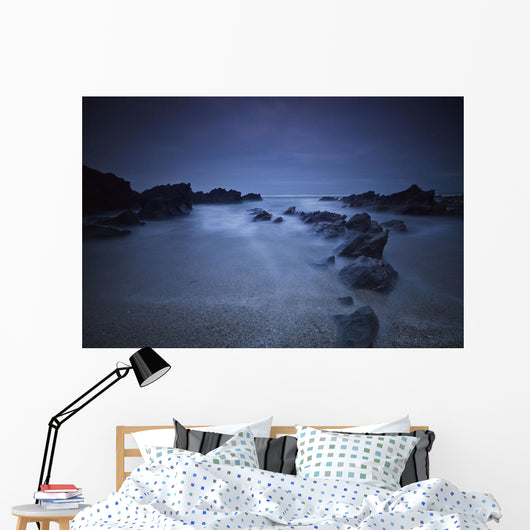 Long exposure of rocks on the beach at night;Newquay cornwall england Wall Mural