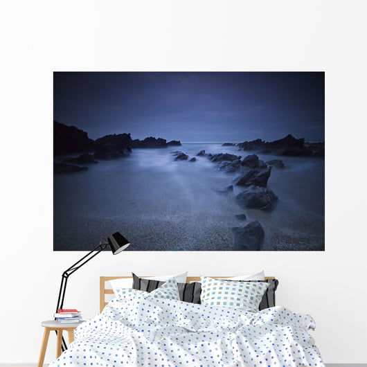 Long exposure of rocks on the beach at night;Newquay cornwall england Wall Mural