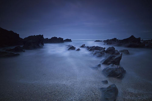 Long exposure of rocks on the beach at night;Newquay cornwall england Wall Mural