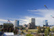 Kites Flying In Park Strip With Downtown Anchorage In Background Wall Mural