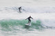 Surfers riding waves Wall Mural