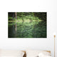 Spruce trees reflected in the glassy surface of a small pond Wall Mural