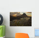 The mountain Kirkjufell rises above the ocean as the sun sets Wall Mural