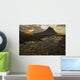 The mountain Kirkjufell rises above the ocean as the sun sets Wall Mural