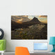 The mountain Kirkjufell rises above the ocean as the sun sets Wall Mural