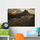 The mountain Kirkjufell rises above the ocean as the sun sets Wall Mural