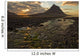 The mountain Kirkjufell rises above the ocean as the sun sets Wall Mural