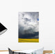 Storm clouds gather over a sunlit canola field in southern Alberta Wall Mural
