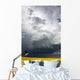 Storm clouds gather over a sunlit canola field in southern Alberta Wall Mural