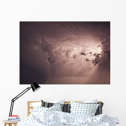 Lightning arcs between clouds during a storm Wall Mural