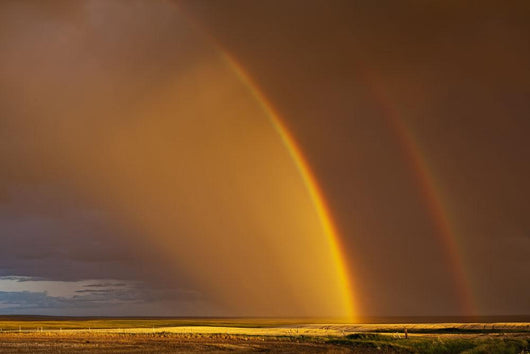 Double rainbow over a prairie field after a storm Wall Mural