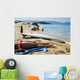 Young woman sunbathing on beach with surf board on sand Wall Mural