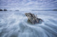 The tide coming in and flowing around a sunken piece of driftwood Wall Mural