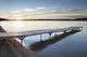 A dock in lake superior at sunset;Thunder bay, ontario, canada Wall Mural