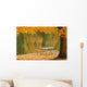 A picnic table beside a tranquil lake with golden leaves on the trees Wall Mural