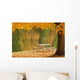 A picnic table beside a tranquil lake with golden leaves on the trees Wall Mural