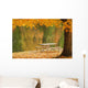 A picnic table beside a tranquil lake with golden leaves on the trees Wall Mural