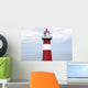 Red and white lighthouse along the coast with a sailboat Wall Mural