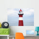 Red and white lighthouse along the coast with a sailboat Wall Mural