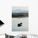 A rowboat sits Wall Mural