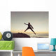 Spain, Andalusia, Cadiz, Costa de la Luz, Surfer jumping from rock Wall Mural