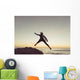 Spain, Andalusia, Cadiz, Costa de la Luz, Surfer jumping from rock Wall Mural