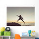 Spain, Andalusia, Cadiz, Costa de la Luz, Surfer jumping from rock Wall Mural