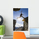 Backlit View Of Hiker Leaping Between Rocks Near Noatak River Wall Mural
