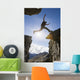 Backlit View Of Hiker Leaping Between Rocks Near Noatak River Wall Mural