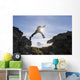 Backlit View Of Hiker Leaping Between Rocks Near Noatak River Wall Mural