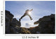 Backlit View Of Hiker Leaping Between Rocks Near Noatak River Wall Mural