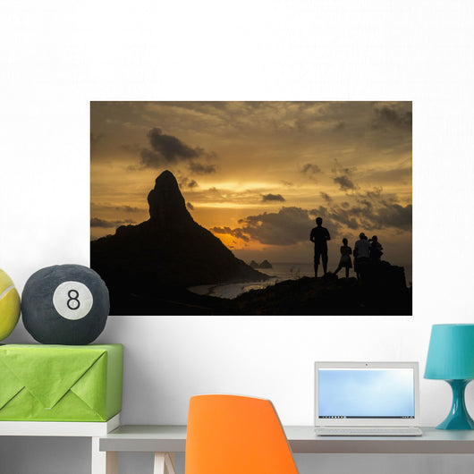 People admiring sunset over Morro do Pico from Forte dos Remedios Wall Mural