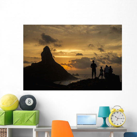 People admiring sunset over Morro do Pico from Forte dos Remedios Wall Mural