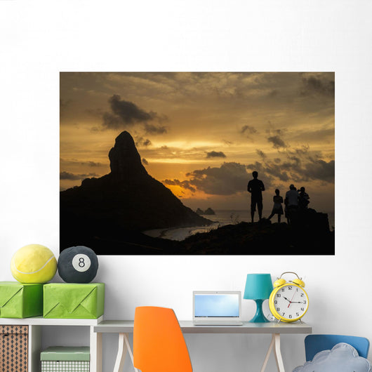 People admiring sunset over Morro do Pico from Forte dos Remedios Wall Mural