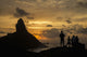 People admiring sunset over Morro do Pico from Forte dos Remedios Wall Mural