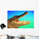 Alligator head with open mouth against a blue and green background Wall Mural