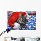 Grey tabby cat with santa claus hat lying Wall Mural