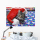 Grey tabby cat with santa claus hat lying Wall Mural