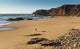 Portugal, Algarve, Distant View Of Surfer Walking On Playa Do Amado Wall Mural