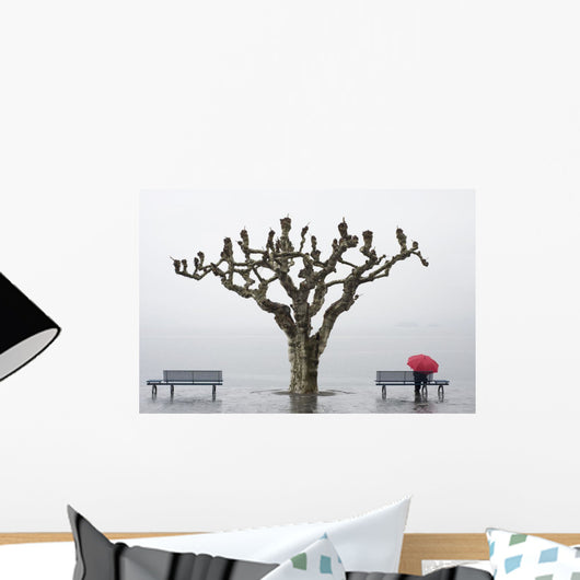 A tree and a person with a red umbrella Wall Mural