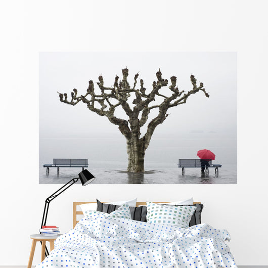 A tree and a person with a red umbrella Wall Mural