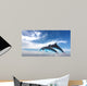 Couple  Of Dolphins Jumping Against The Blue Sky Wall Mural