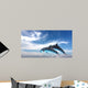 Couple  Of Dolphins Jumping Against The Blue Sky Wall Mural