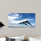 Couple  Of Dolphins Jumping Against The Blue Sky Wall Mural