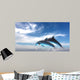 Couple  Of Dolphins Jumping Against The Blue Sky Wall Mural